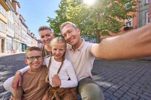 a family posing for a picture on the street at Pension Bergstube in Bad Langensalza
