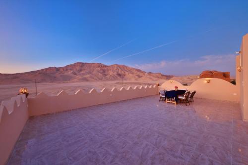 a room with a table and chairs on a roof at El Hanna Valley View in Luxor