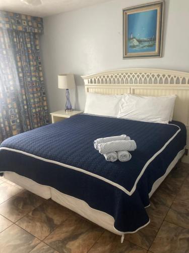 a bedroom with a bed with a teddy bear on it at Ocean Walk Resort 911i - 828 in Daytona Beach