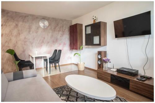 a living room with a couch and a table at Apartament Zdrojowy in Busko-Zdrój