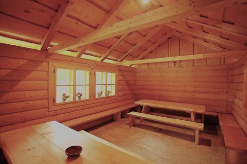 a log cabin with a bench and a window at Chata Škerda - Zuberec in Zuberec