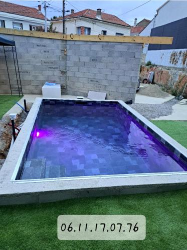 une grande piscine dans une cour avec un panneau dans l'établissement Charmant appartement proche des arènes, à Béziers