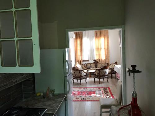 a kitchen with a living room with a table and chairs at ANTIQUE HOUSE (ANTALYA CENTER) in Antalya
