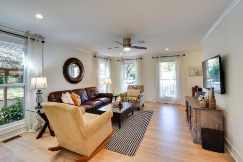a living room with a couch and a tv at Tranquil Travelers Rest Home with Fire Pit! in Travelers Rest