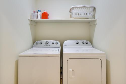 a kitchen with two white appliances and a shelf at Tranquil Travelers Rest Home with Fire Pit! in Travelers Rest