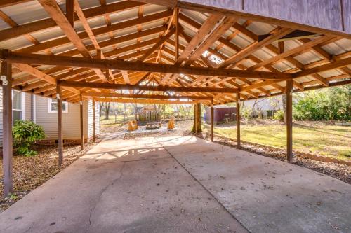 an outdoor patio with a wooden pergola at Tranquil Travelers Rest Home with Fire Pit! in Travelers Rest