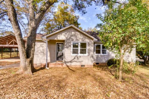 a house with a tree in the yard at Tranquil Travelers Rest Home with Fire Pit! in Travelers Rest