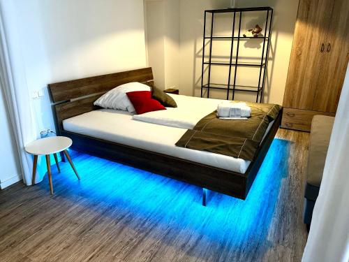 a bedroom with a large bed with a blue floor at BeeFree WhirlpoolSuiteXL33-FreeParking-FastWiFi in Passau