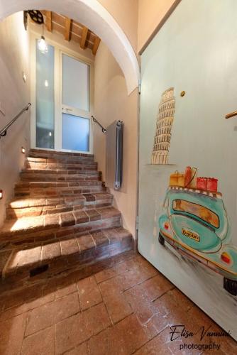 a room with stairs with a painting on the wall at La Mi Casina Toscana in Palaia