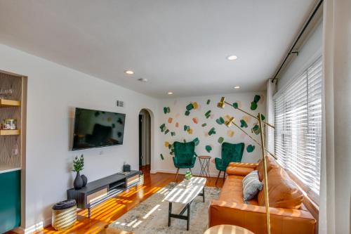 a living room with a couch and a tv at Dreamy St Charles Retreat with Furnished Patio! in St. Charles