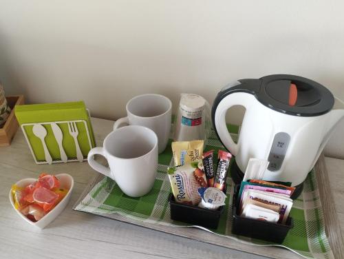 a table with a tea kettle and cups on it at Agriturismo Casale Lisalola in Sutri