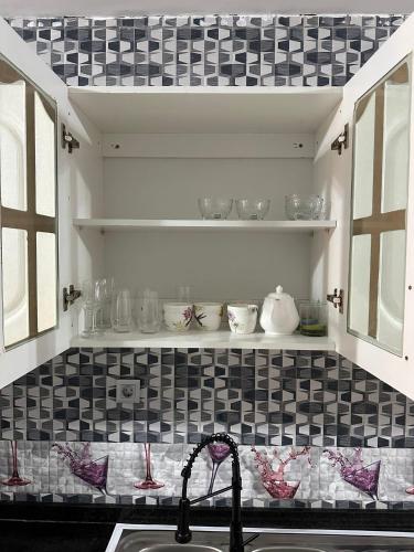 a kitchen with black and white tile on the wall at Lovely house in Luanda Centre with treadmill in Luanda