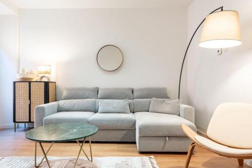 a living room with a couch and a table at New premium flat - Malaga Center in Málaga