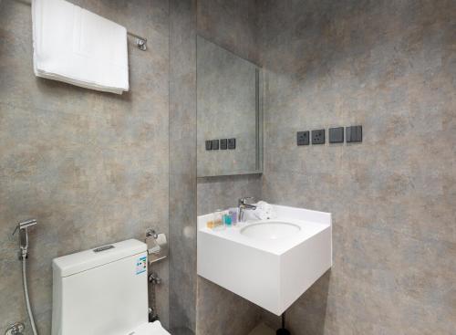 فندق كارم الذهبي KAREM ALZAHBI HoteL في المدينة المنورة: حمام مع حوض أبيض ومرحاض