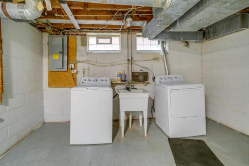 a laundry room with two washers and a sink at University Heights Home Near Downtown Cleveland! 