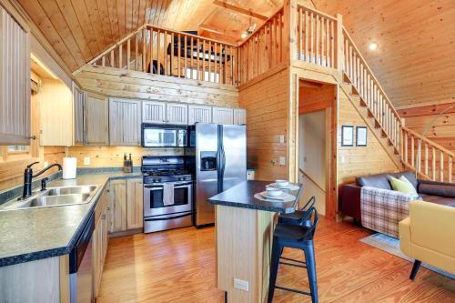 a kitchen with a stainless steel refrigerator and a staircase at Mtn-View Blue Ridge Cabin on Over 2 Acres! in Sparta