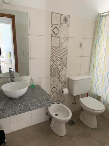 a bathroom with a toilet and a sink at Departamento Mirta in Esquel