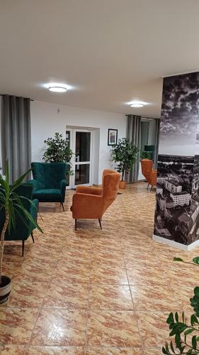 a lobby with couches and chairs in a building at Hotel Piast in Myślibórz