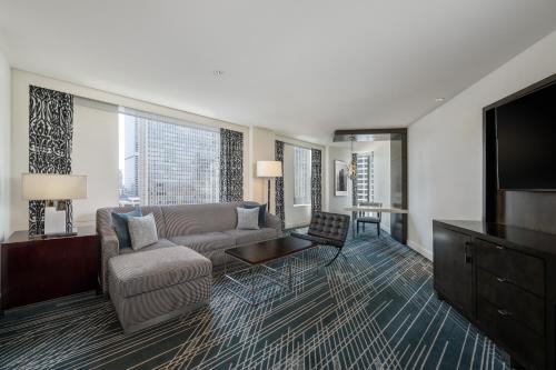 a living room with a couch and a flat screen tv at Sofitel Chicago Magnificent Mile in Chicago