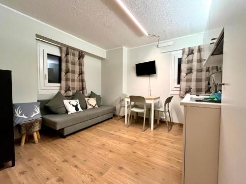 a living room with a couch and a table at Chalet Fiocco di neve, Passo del Tonale in Passo del Tonale