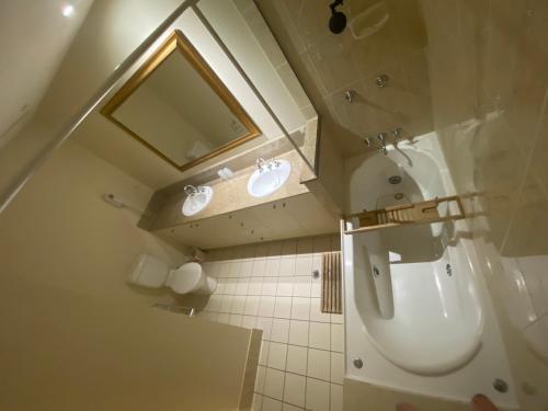 a small bathroom with a toilet and a sink at Lakes Resort 1 Bedroom Apartment in Edge Hill