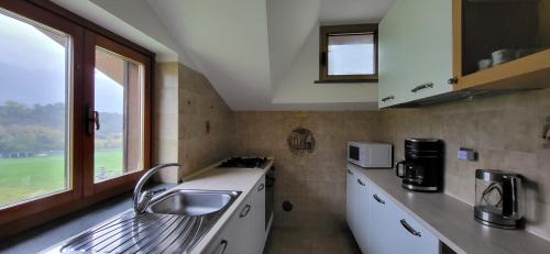a small kitchen with a sink and a window at Casa Estulio in Pontey