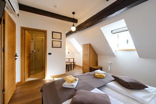 a bedroom with two beds in a attic at Old Parish House in Bled
