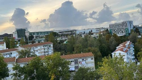 a view of a city with buildings and trees at airport room in Lisbon