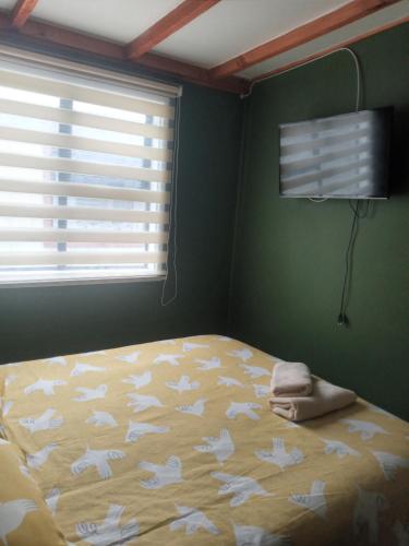 a bedroom with a bed with white butterflies on it at Cabaña Gesell in Puerto Natales