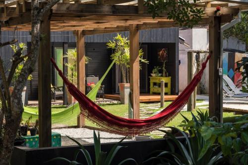 a hammock in the middle of a garden at Pousada Vila do Mel in Pontal do Paraná
