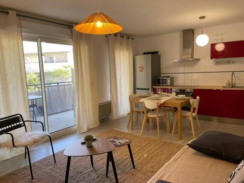 un salon avec une cuisine et une salle à manger dans l'établissement Appartement Montpellier Nord 6 personnes, à Montpellier