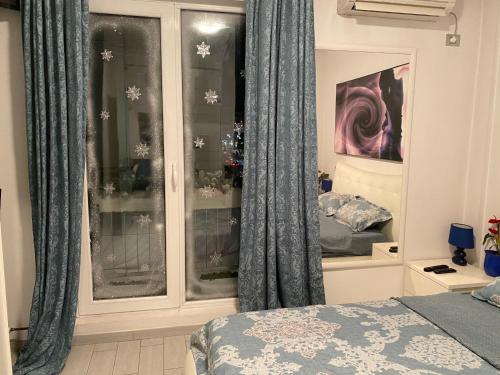 a bedroom with blue curtains and a bed and a window at Blue light ultracentral in Craiova