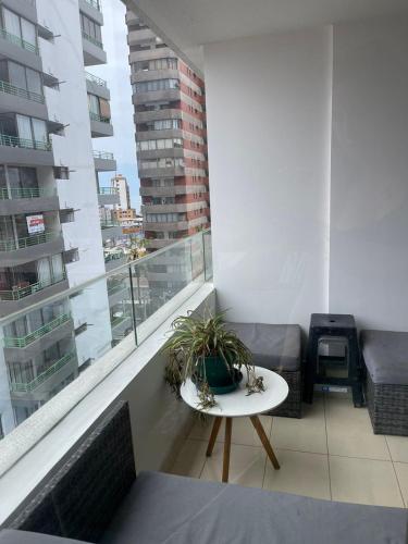 a balcony with a table with a plant on it at DEPARTAMENTO EDIFICIO AZUL l in Iquique