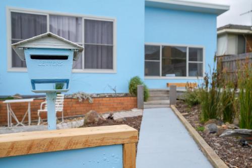 a blue mailbox in front of a house at A Wave from it All in Warrnambool