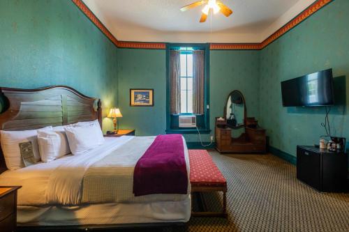 a bedroom with a bed and a flat screen tv at 1886 Crescent Hotel and Spa in Eureka Springs