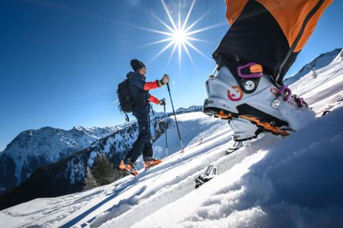 a man standing on skis on a snow covered mountain at Landhaus Riepler in Wagrain