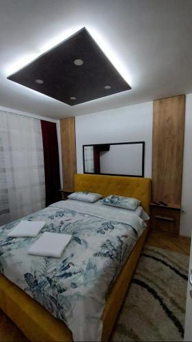 a bedroom with a large bed with at Apartman Luna in Valjevo