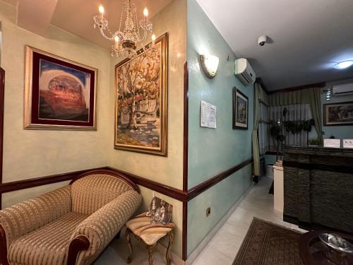 a living room with a couch and a chandelier at Beatrix Lux Hotel in Budva
