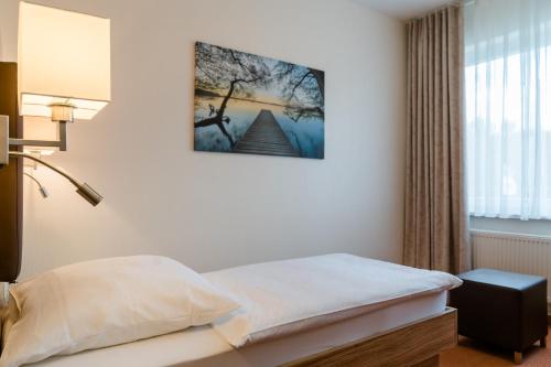 um quarto de hotel com uma cama e uma janela em Hotel Falkenhagen em Pritzwalk