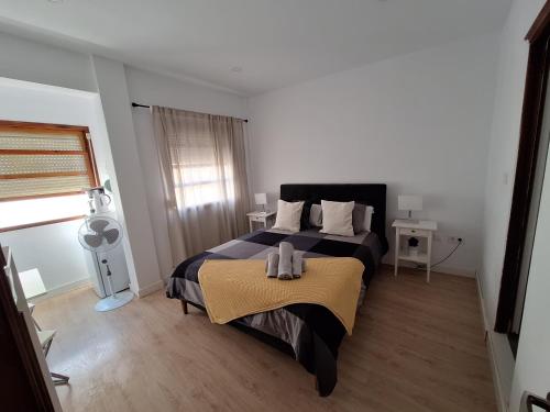 a bedroom with a bed with a blanket on it at habitacion con baño privado en un piso con familia in Santa Cruz de la Palma