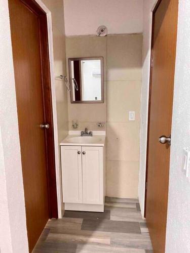 a bathroom with a white sink and a mirror at Casa para vacacionar in Cabo San Lucas