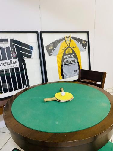 a ping pong table with a ping pong ball and a paddle at Real NOB Hotel in Orleans