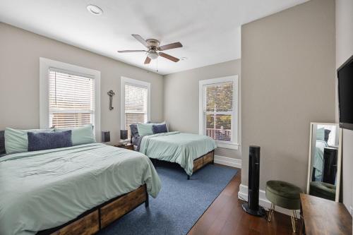 um quarto com 2 camas e uma ventoinha de tecto em Charming Craftsman close by Bishop Arts & Downtown em Dallas