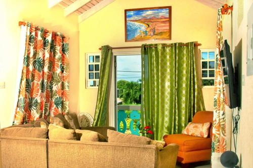 a living room with a couch and a window at Cozy Modern Upstairs 2 Bed A/C Apt Near 2 Everything in Saint Philip
