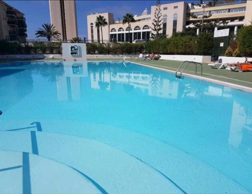 a large swimming pool with blue water at Cristimar H23 big pool, 3 bedroom and 3 baths in Los Cristianos