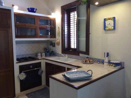 a kitchen with a sink and a counter top at Villa Giuliana in San Vito lo Capo