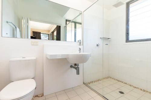 a bathroom with a toilet and a sink and a shower at Boom 1 in Blueys Beach