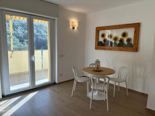 a dining room with a table and chairs and a window at La Terrazza di Mimì in Levanto