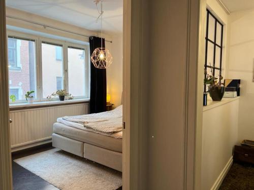 a bedroom with a bed and a window at Apartment in the middle of So-Fo, Södermalm, 67sqm in Stockholm