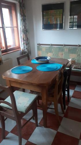 a dining room table with blue pillows on it at Chata Salicka Bozkov in Bozkov